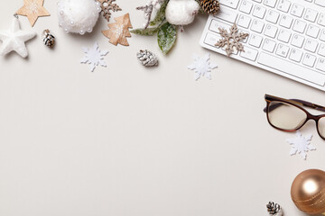 Working desk. Christmas ornament glasses keyboard on the gray table. Flat lay top view copy space
