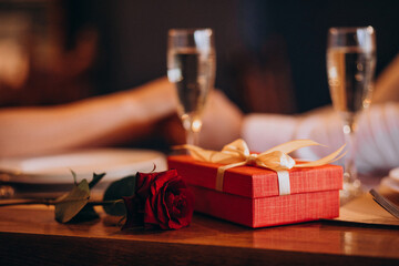 Couple holding hands on valentines evening in a restaurant