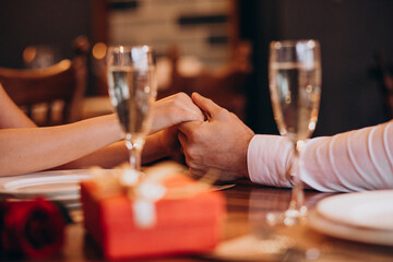 Couple holding hands on valentines evening in a restaurant
