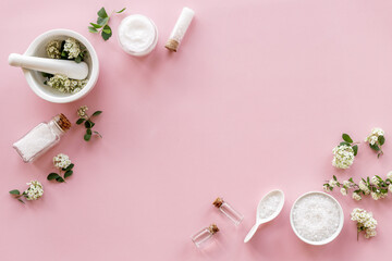 Fototapeta na wymiar White herbal skin cream and bath salt - spa cosmetic with flowers