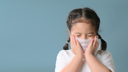 Little asian girl sick and sad with sneezing on nose and cold cough on tissue paper becauseweak or virus and bacteria from dust weather and kindergarten and kindergarten school for medical.