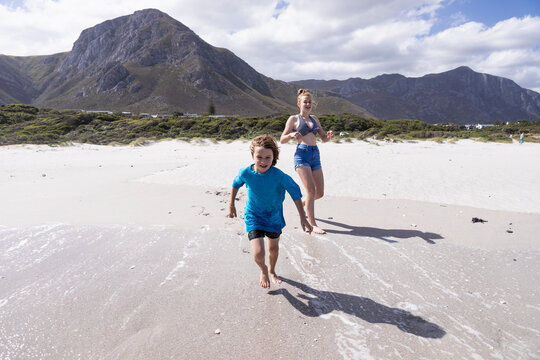 Children playing in surf, Grotto Beach, Hermanus, Western Cape, South Africa.