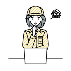デスクで座ってPCを開いて困っている作業員の女性