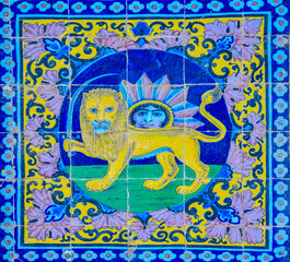 Iranian symbol of lion and sun tiles on a wall of Golestan palace in Tehran, Iran