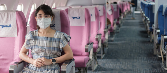 Young woman wearing protective face mask in airplane or public transportation, protection Coronavirus disease infection, Asian tourist ready to travel. Next Normal and reopening concept