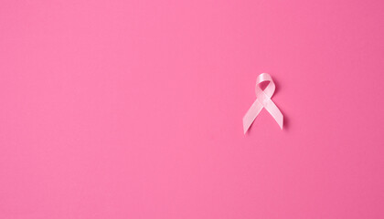 pink silk ribbon in the form of a loop on a pink background.