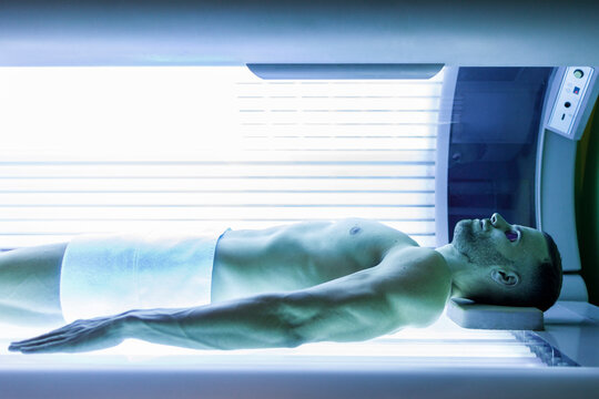 Sportsman with protective eyewear under UV light bed