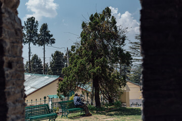 Man relaxing on Church grounds bench