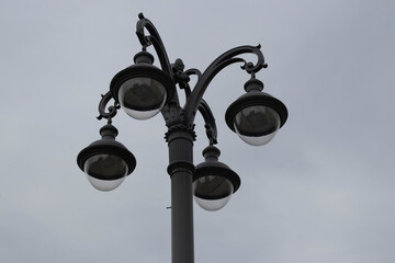 Fototapeta na wymiar modern street lamp four candles