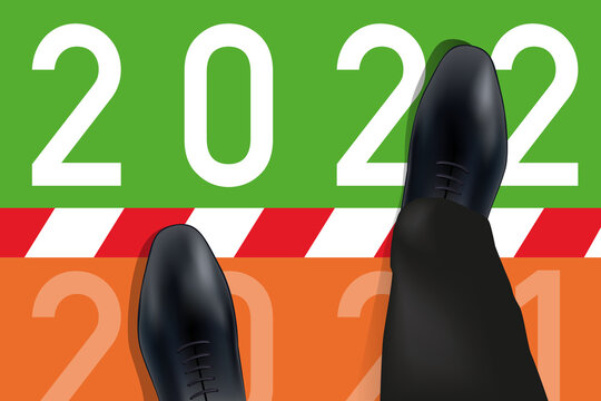 Carte de vœux 2022 montrant les pieds d’un homme vue du dessus qui franchissent une ligne symbolisant le passage à la nouvelle année.
