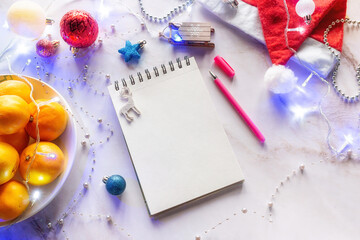 new year christmas decorations and notebook with place for text concept shopping wish list for new year christmas