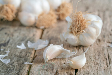 bulb and cloves of garlic on wooden surface