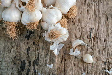 bulb and cloves of garlic on wooden background
