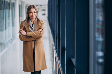 Young business woman in coat waiting in terminal