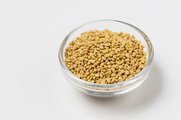 Macro photo of flower bee pollen in a glass cup on white