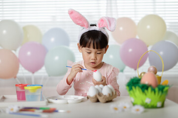 young girl making easter craft at home