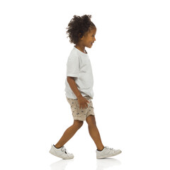 Sneaking little black boy. Side view. Full length, isolated. - 473312330