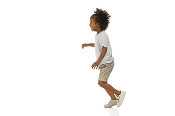 Smiling little black boy is running. Side view. Full length, isolated. - 473312335