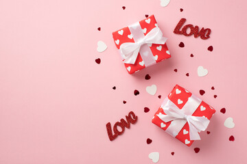Top view photo of valentine's day decorations two gift boxes in red wrapping paper with pattern of...