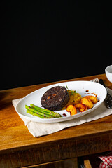 Black pudding with green asparagus and fried apple