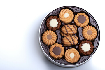 Assorted cookies set in a round box on white background for the new year.
