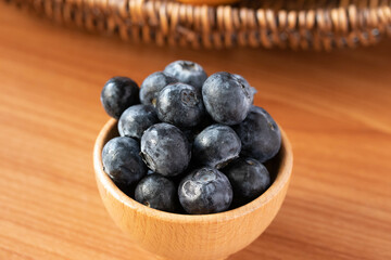 fresh blueberries in a wooden cup