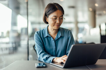 Busy adult, asian woman, checking the company budget
