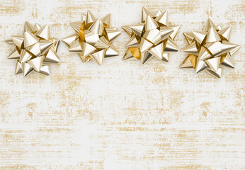 Christmas background with gold bows on grunge white and gold