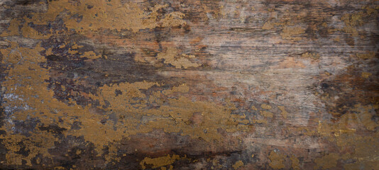 Wooden wall with old crumbling paint. The texture of the old painted board. The orange paint has cracked with age.