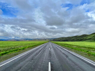 Fototapeta premium The road goes into the distance in the mountains, a part of the Chuisky tract , Altai, Russia