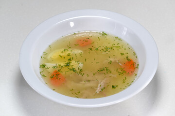 soup in a white plate on a white background
