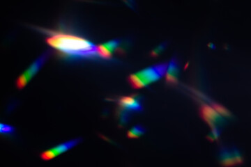 Blur colorful warm rainbow crystal light leaks on black background. Defocused abstract retro film...