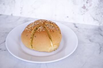 Garlic cream cheese bread or cheese bun, mozzarella cheese bun with sesame and parsley for serve on a white plate
