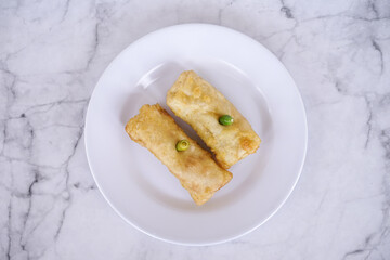 Sosis solo or solo rolls on a white plate, is a traditional food from solo, central java, indonesia