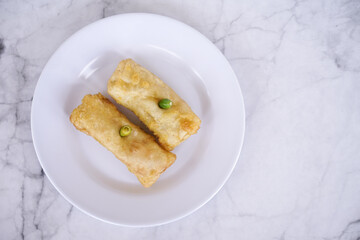 Sosis solo or solo rolls on a white plate, is a traditional food from solo, central java, indonesia