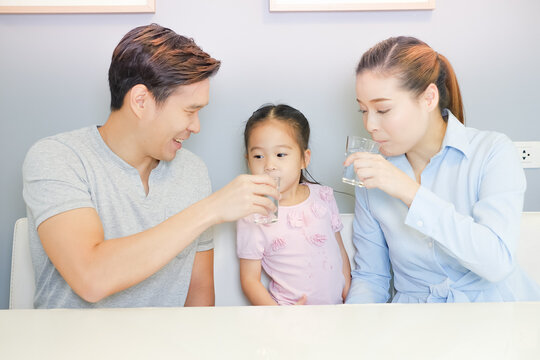 Asia Family Drinking Water With Together