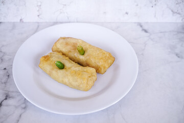 Sosis solo or solo rolls on a white plate, is a traditional food from solo, central java, indonesia