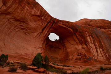Panorama view of Bowtie Arch on the Corona Arch hiking trail after thunderstorm. Moab, Utah, USA.