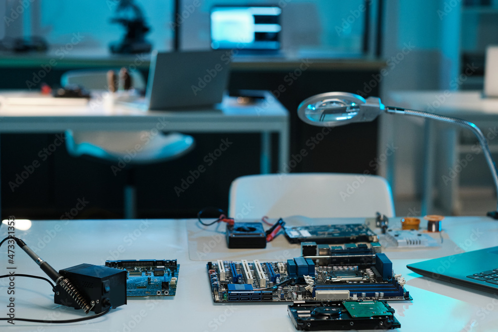 Poster workplace of engineer or technician with motherboard or circuit board, soldering iron and magnifying