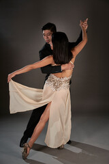 Tango couple of latin woman and asian man. ballroom. Studio shoot