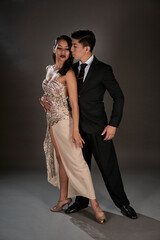 Tango couple of latin woman and asian man. ballroom. Studio shoot