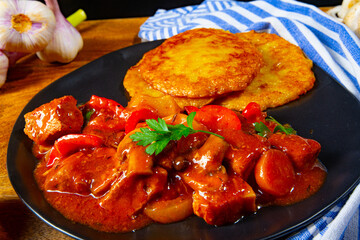 Original Hungarian goulash with potato pancakes