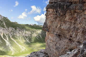 Three colors of nature. Blue sky, green meadows and Italian Dolomite rocks