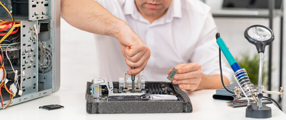 a man repairs motherboard. computer repair shop. professional services. 