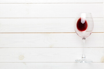 One glasses of red wine at wine tasting. Concept of red wine on colored background. Top view, flat lay design