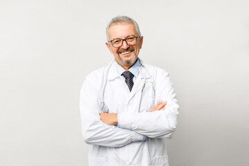 Portrait of an elderly male doctor on a white background. Friendly doctor smiling while looking at...