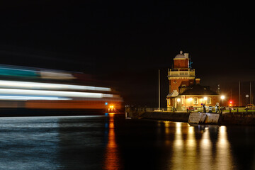 Fototapeta na wymiar Ferry leaving port of Helsingborg at night. Destination is Helsingor, Denmark. Long exposure photo. Selective focus.