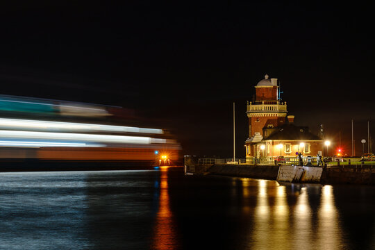 Ferry leaving port of Helsingborg at night. Destination is Helsingor, Denmark. Long exposure photo. Selective focus.