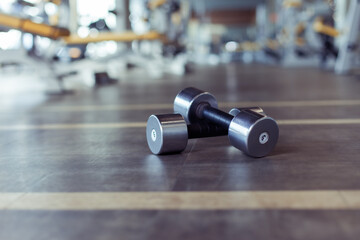 Metal dumbbells on the gym floor. Bodybuilding and fitness concept