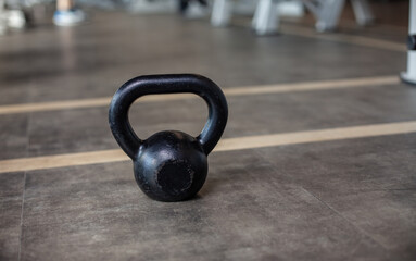 Fototapeta na wymiar Kettlebell on the gym floor. Bodybuilding and Fitness
